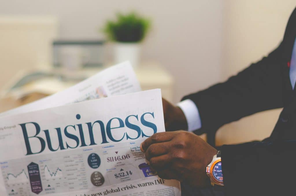 Image of a man reading a financial newspaper